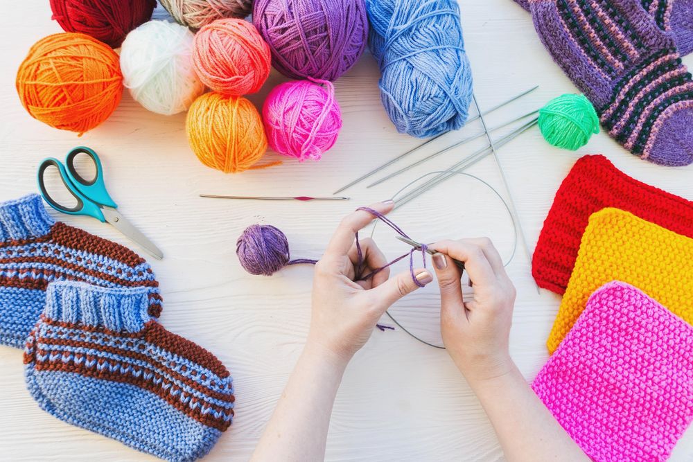 Woman knitting using colorful yarn