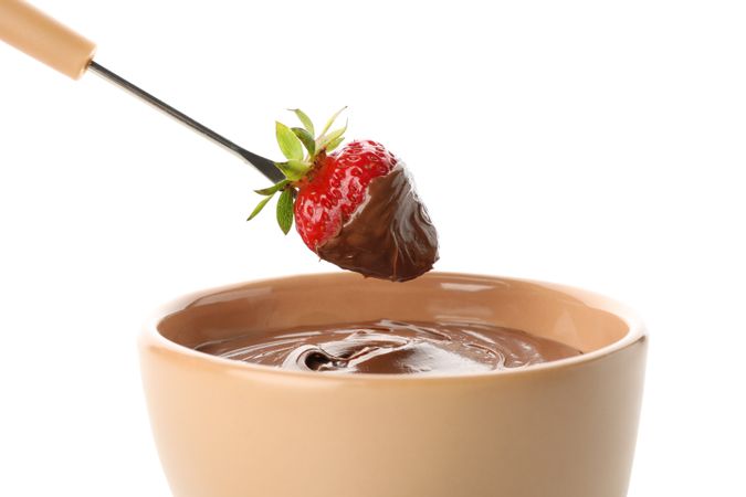 Chocolate fondue. Strawberry in chocolate isolated on blank background