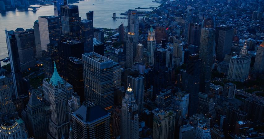 Aerial View of Lower Manhattan Architecture. Evening Shot of Financial Business District from a Helicopter. Scenery of Historic Office Towers, Including 40 Wall Street Building with Green Roof