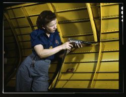 Nashville, TN, USA - 1943: Woman is working on a "Vengeance" dive bomber 4Alvq5