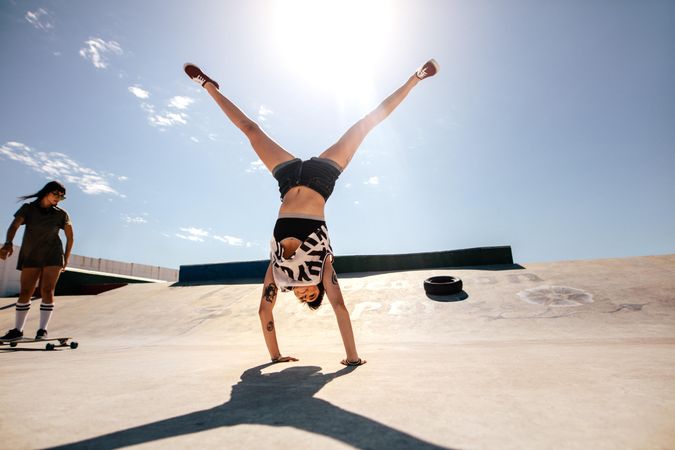 Female doing stunts at skate park