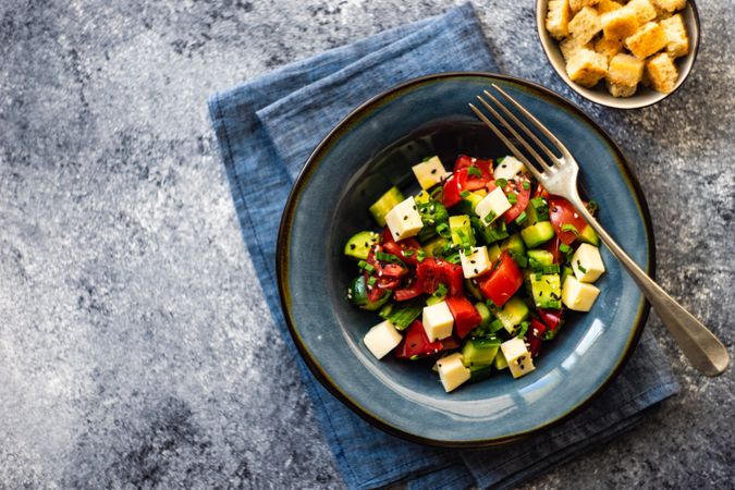 Top view of healthy Greek salad with fresh vegetables and cubed cheese