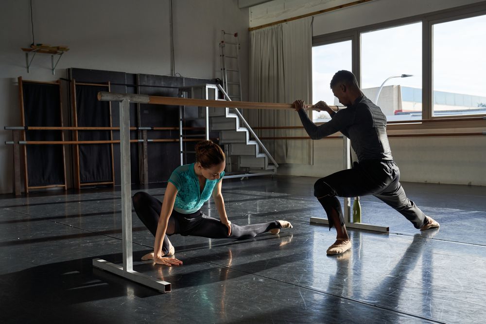 Couple of dancers in a class doing a training in ballet academy