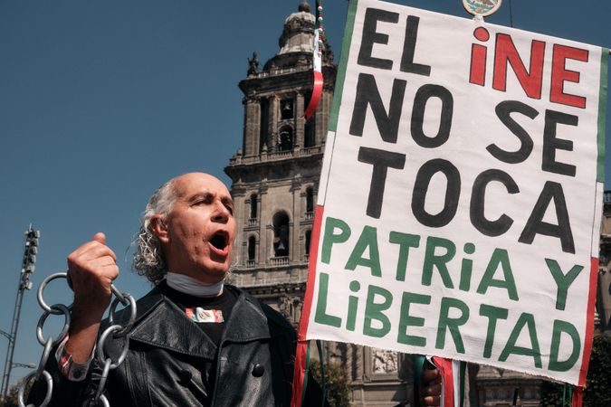 Mexico City, Mexico - February 26th, 2022: Passionate man calling out in protest with sign