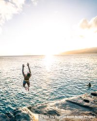 Man Jumping Into The Sea While Another Man Swimming - Free Photo ...