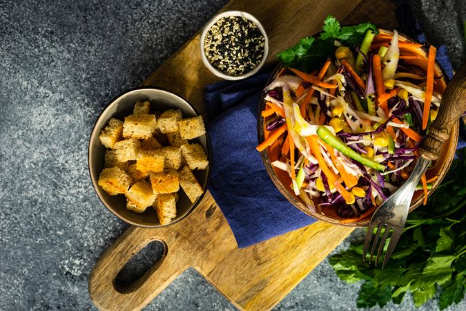 Top view of healthy bowl of fresh salad with vegetables on stone background with copy space