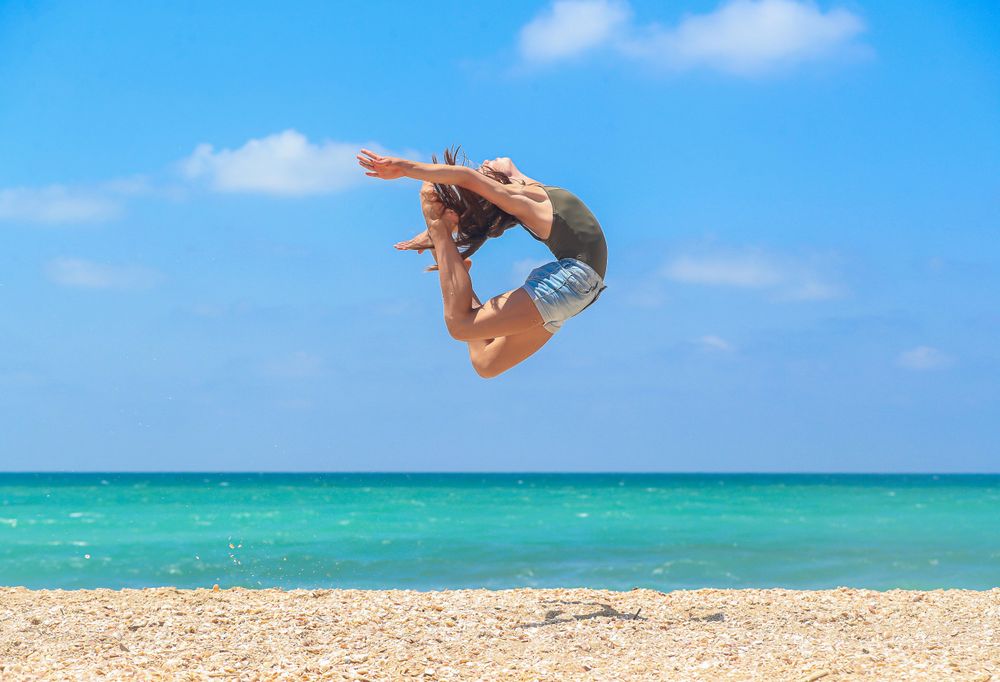 Woman jumping on the beach
