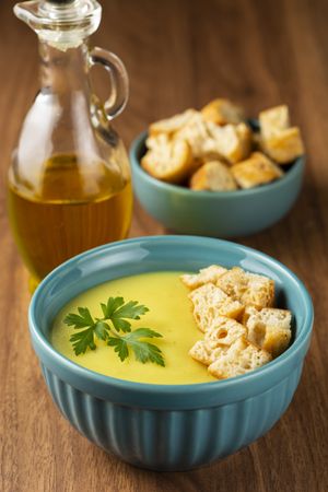 Bowl with onion soup and croutons on the table.
