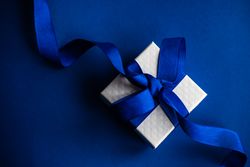 Valentine present with blue ribbon on blue table