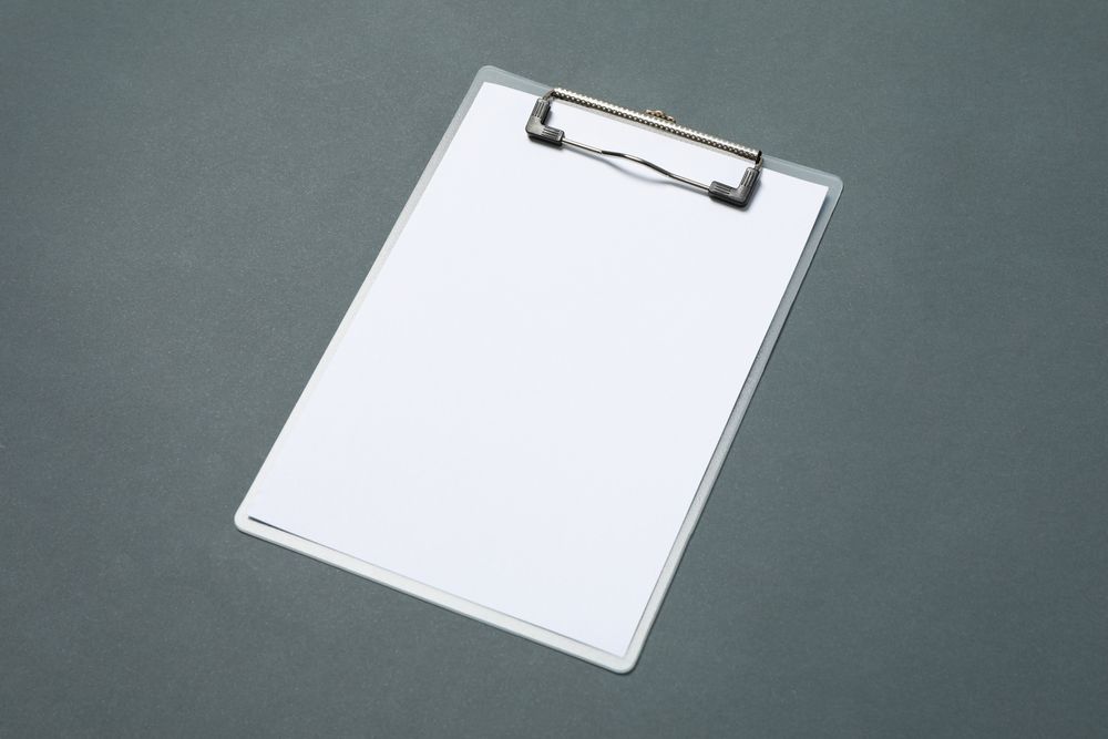 Empty clipboard on light dark background, space for text