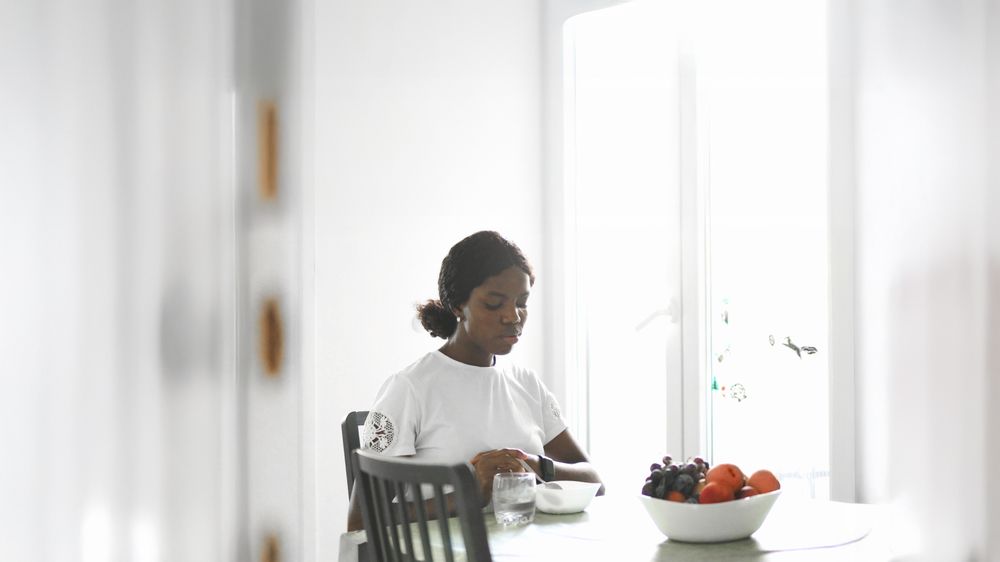 Casual Morning Scene: Woman Eating Cereal at Home.