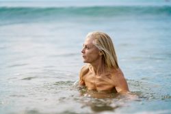 Muscular older woman in bathing in the sea