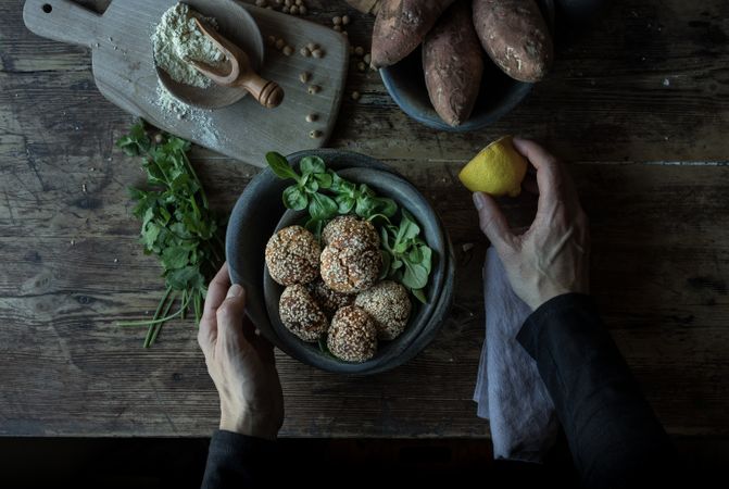 Person rolling in breadcrumbs sweet potatoes