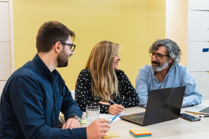 Cheerful colleagues working together on project in office
