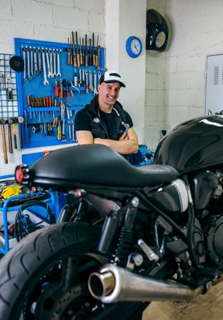 Mechanic posing with a motorcycle
