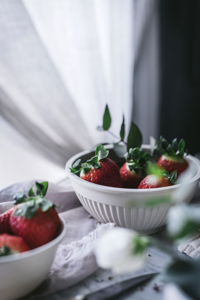 Strawberries and flowers on marble table