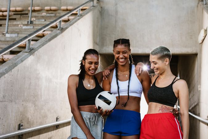 Three multi-ethnic female soccer players at the stadium