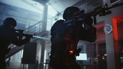 Close Up Portrait of Masked Armed SWAT Police Officer Storm a Dark Seized Office Building with Desks and Computers.
