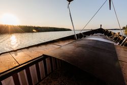Front of boat riding along sea