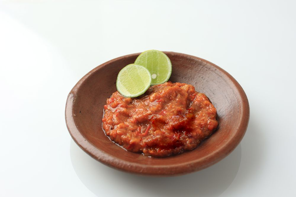 Sambal Tomat or Spicy Tomato Paste on Earthenware Plate
