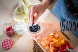 Crop woman preparing healthy food