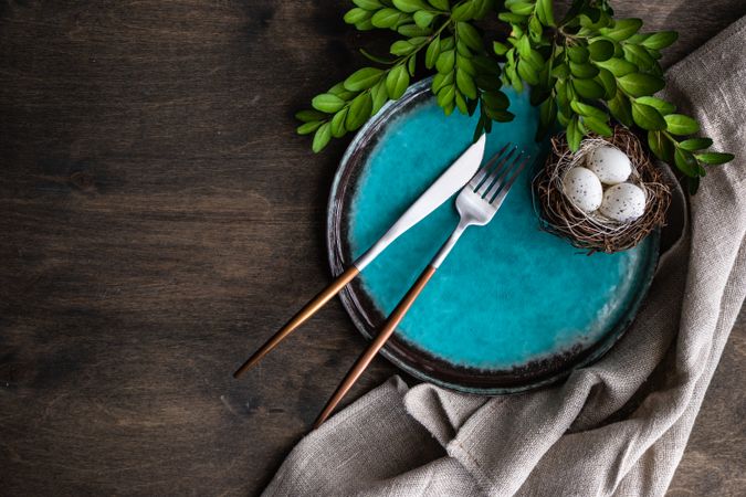 Top view of teal plate with nest for spring table setting