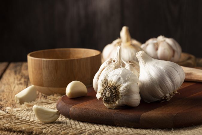 Garlic bulb and garlic cloves on the wooden table.