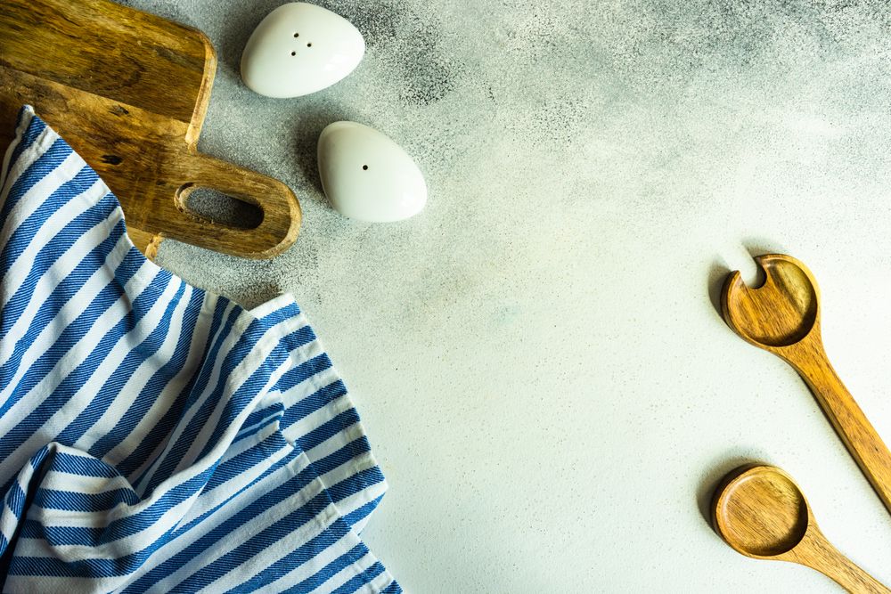 Modern salt and pepper shaker with wooden spoons on kitchen counter with copy space