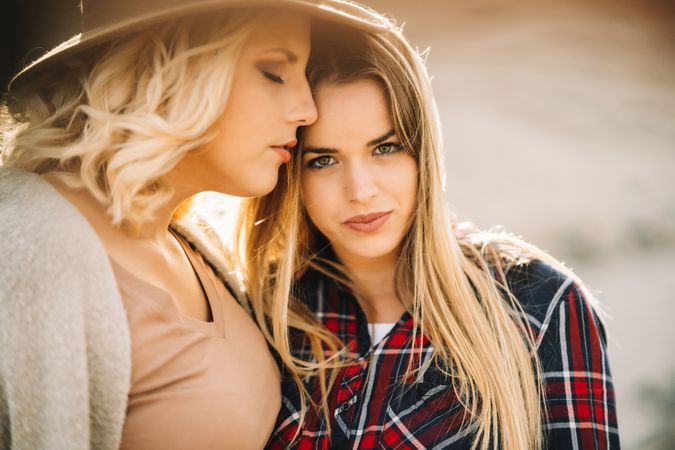 Content blond women cuddling on nature