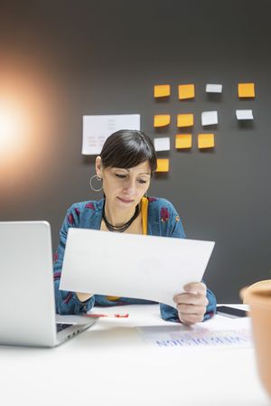 Smiling businesswoman working with documents
