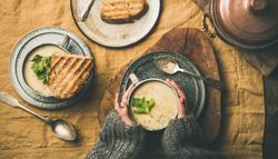 Woman with celery soup in cup