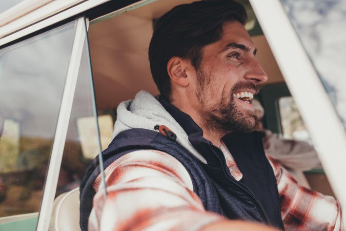 Man driving a van and smiling