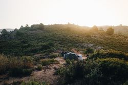 Motorcycle with tent in a field, landscape