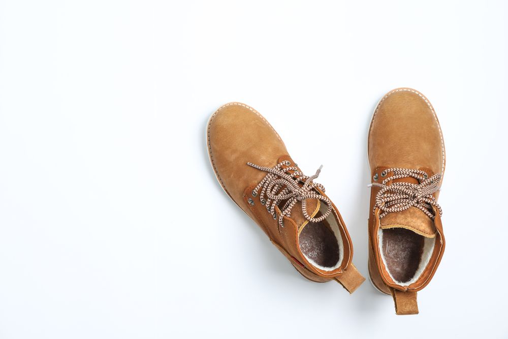 Winter boots on blank background, top view