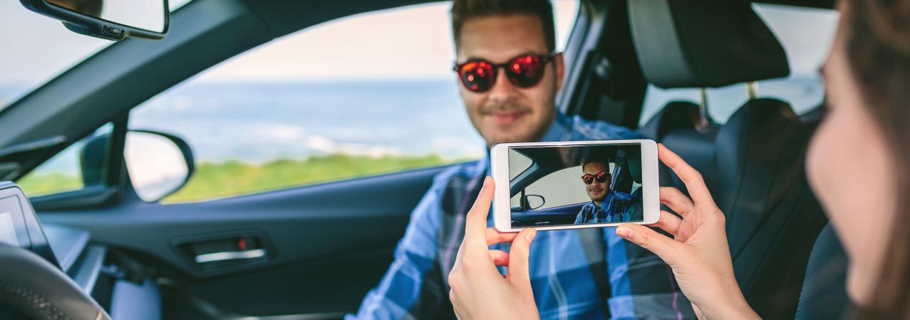Woman taking picture with mobile to her boyfriend