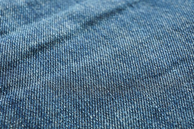 Texture of blue jeans as background, space for text