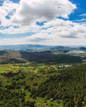 Breathtaking white clouds above hills with greenery