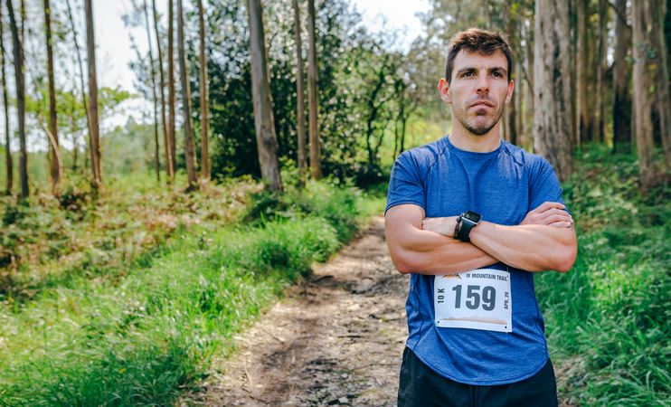Male trail athlete posing with race number