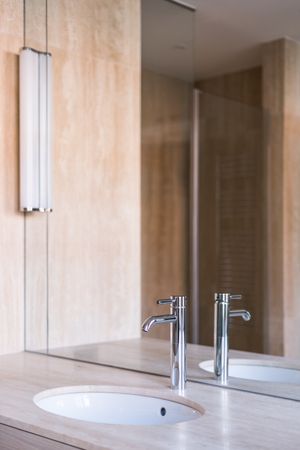 Sink with wooden counter in stylish bathroom