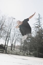 Young man in air dancing break dance in park