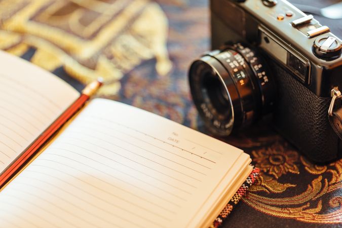 Notebook next to a vintage camera