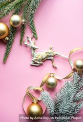 Christmas pine and golden decorations on pink background 56OWP4