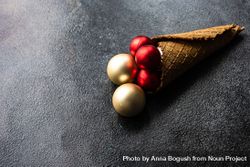 Christmas concept of cone with red and gold baubles 0VXzN4