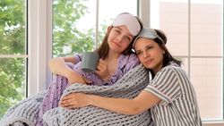 Mother and daughter enjoying a quiet moment by the window.
