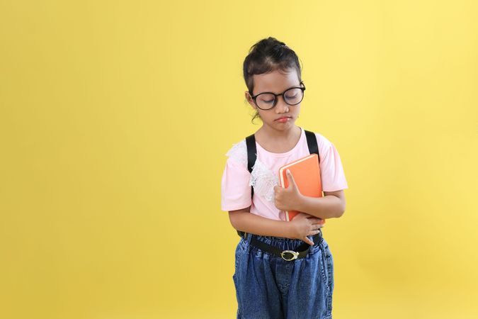 Asian Little Girl Kid Pouting with Backpack and Book, Refuses to Go to School