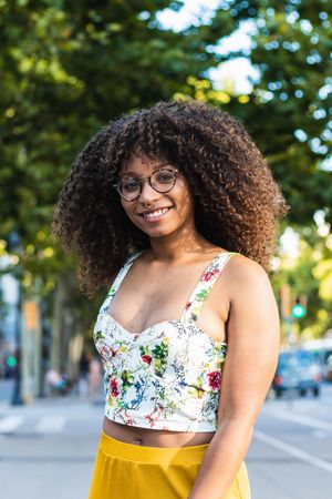 Glad Black woman looking at camera in park