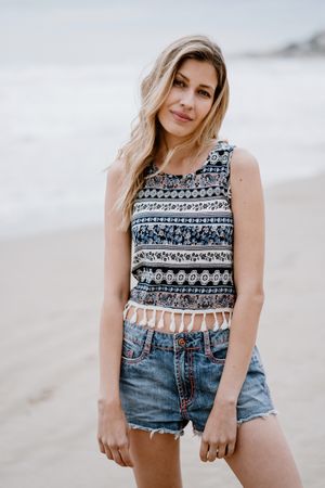 Happy female posing on sandy beach