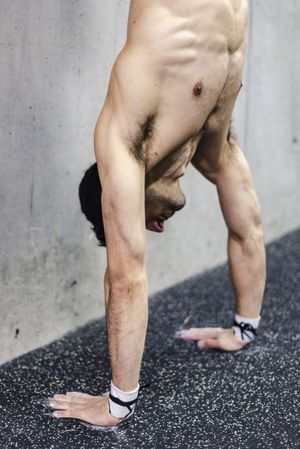 Man doing handstand in gym
