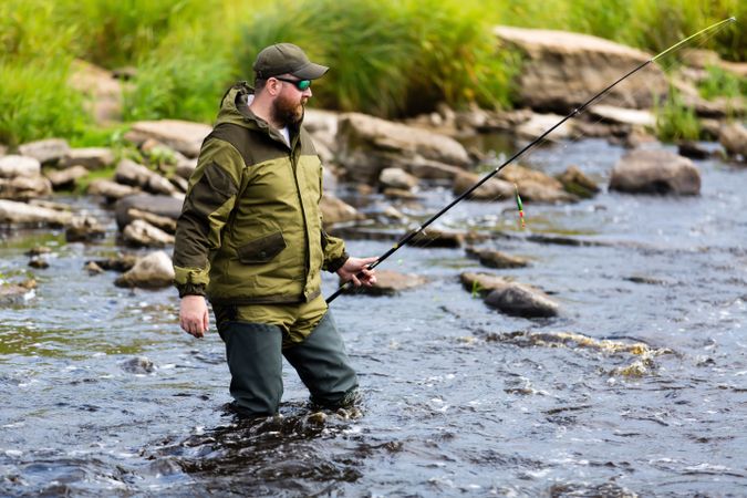 Rugged fisherman fishing in the water