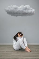 Unrecognizable woman  under a dark cloud